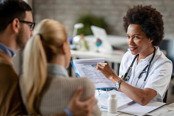 Private Health Insurance being discussed between a doctor and patients during a medical consultation.