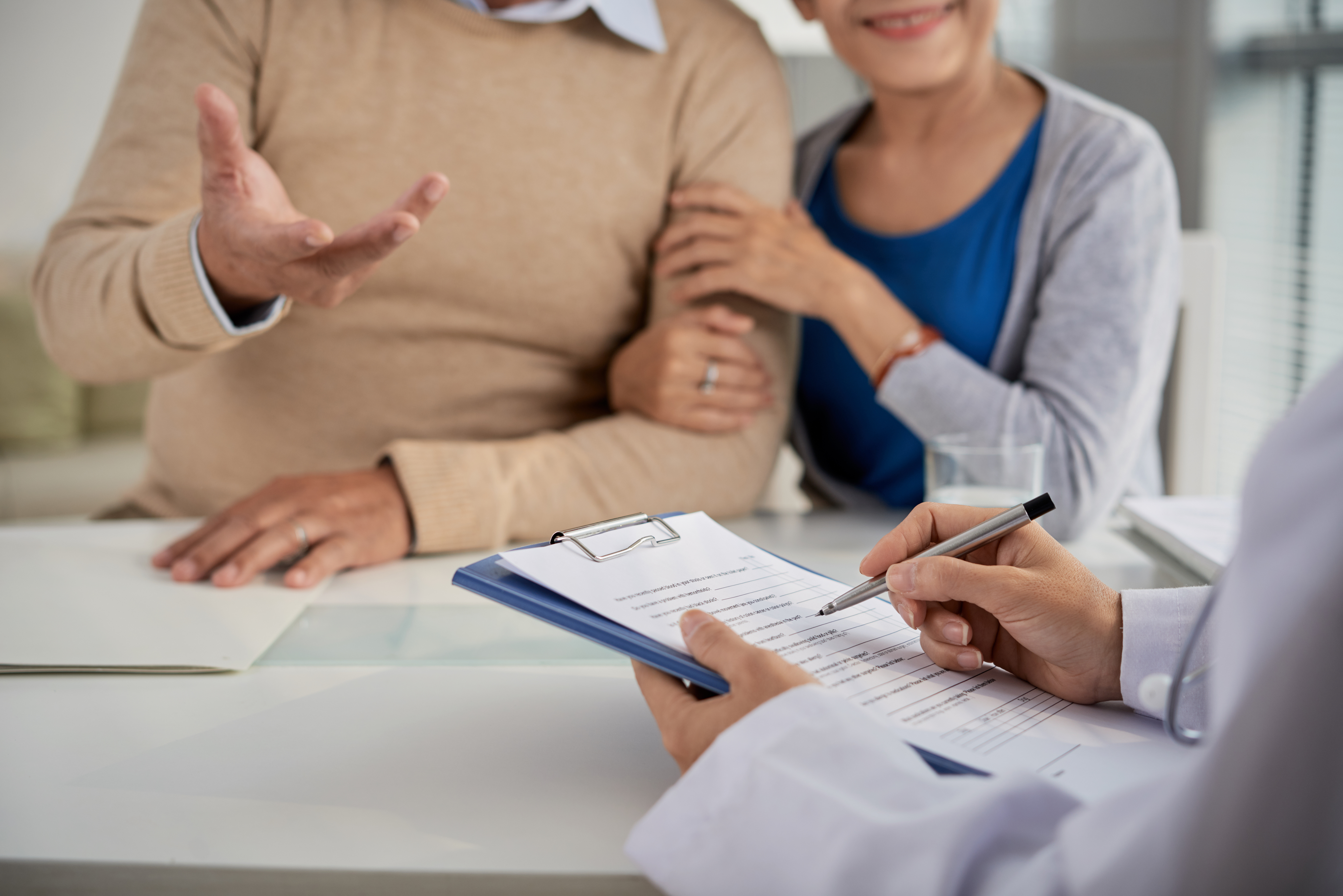 Retired couple discussing company health insurance after retirement and future healthcare options.