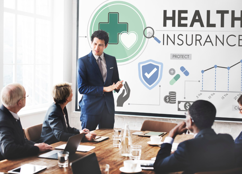 Senior staff memembers in a meeting discussing small business health insurance plans to choose from.